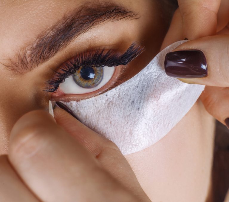 Eyelash Extension Procedure. Woman Eye with Long Blue Eyelashes. Ombre effect. Close up, selective focus.